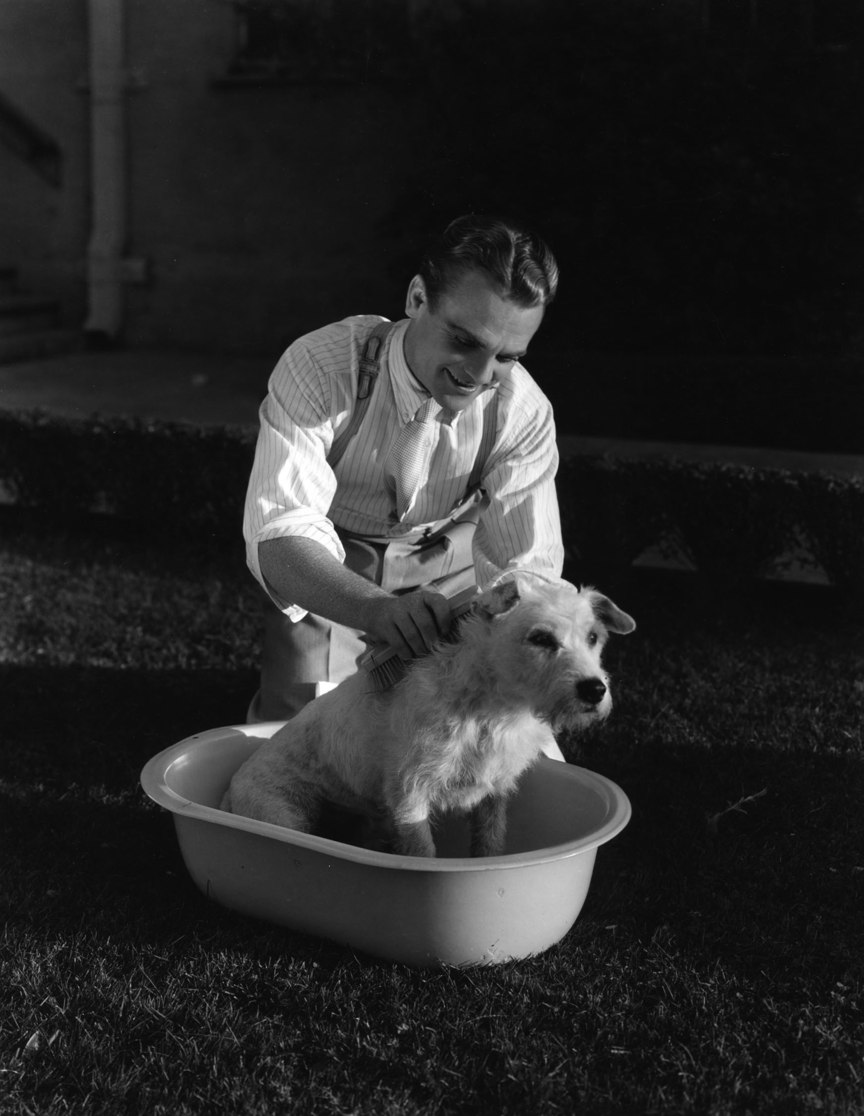 James Cagney washes a puppy, circa 1933.