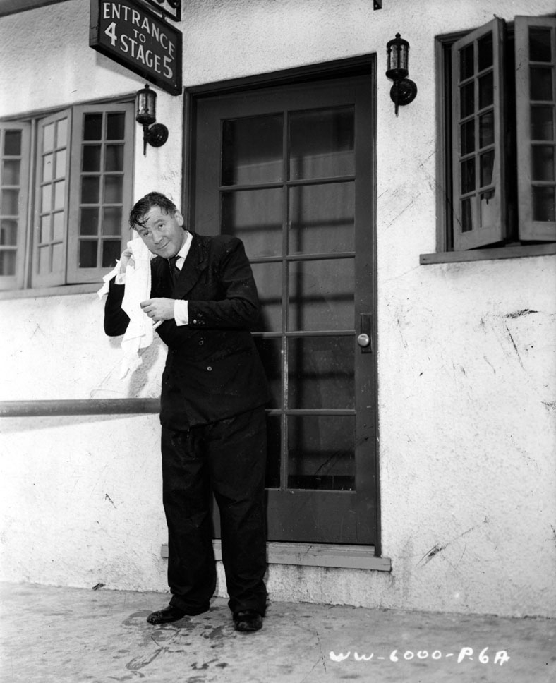 Herbert Marshall dries off after a dip in the water tank