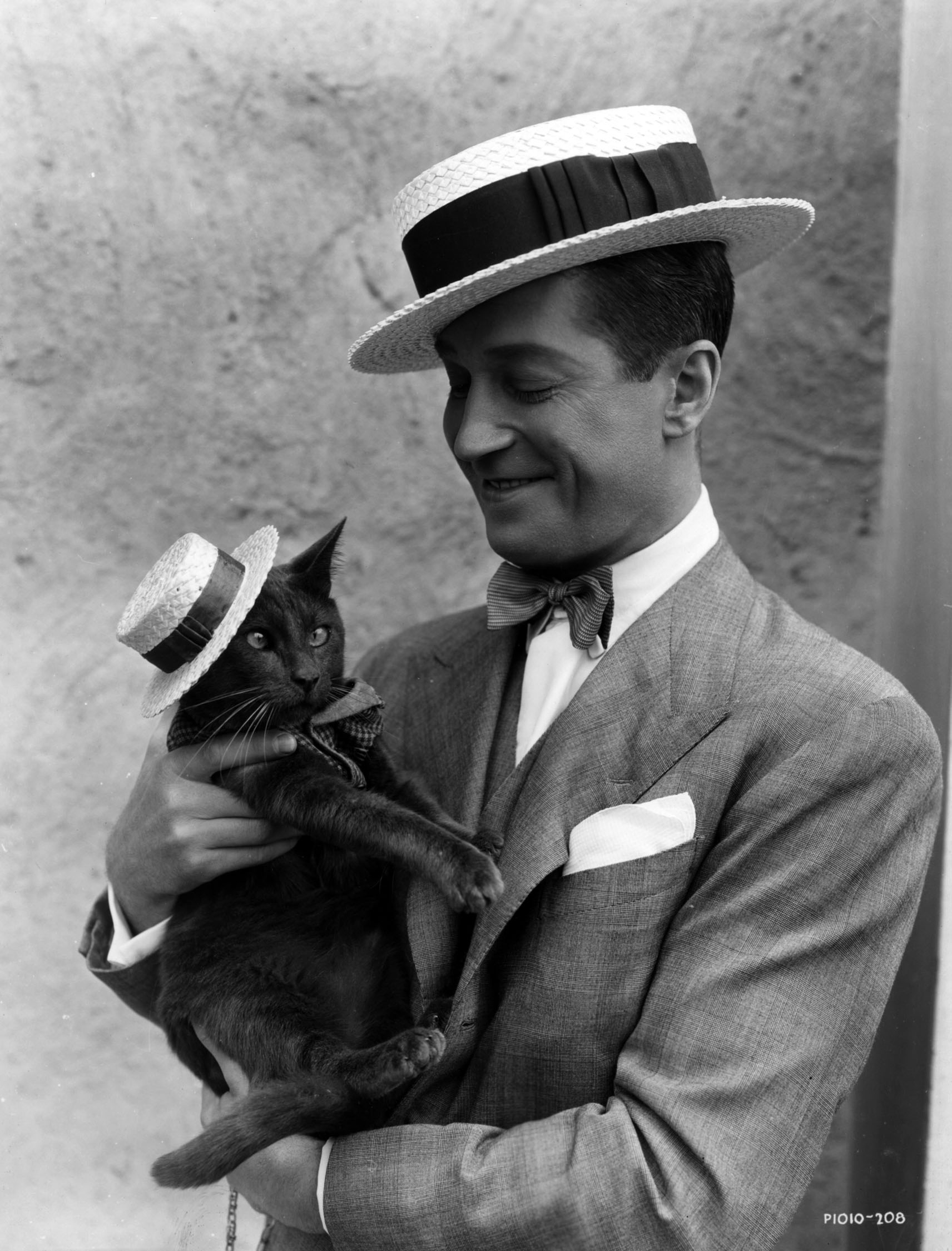 Maurice Chevalier and his (cross-eyed) cat.