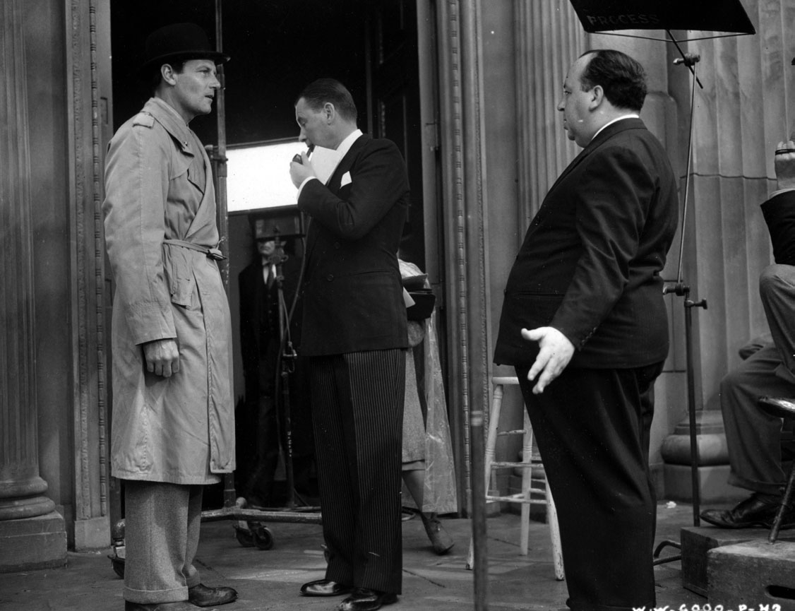 McCrea, Marshall, and Hitchcock discuss a scene.