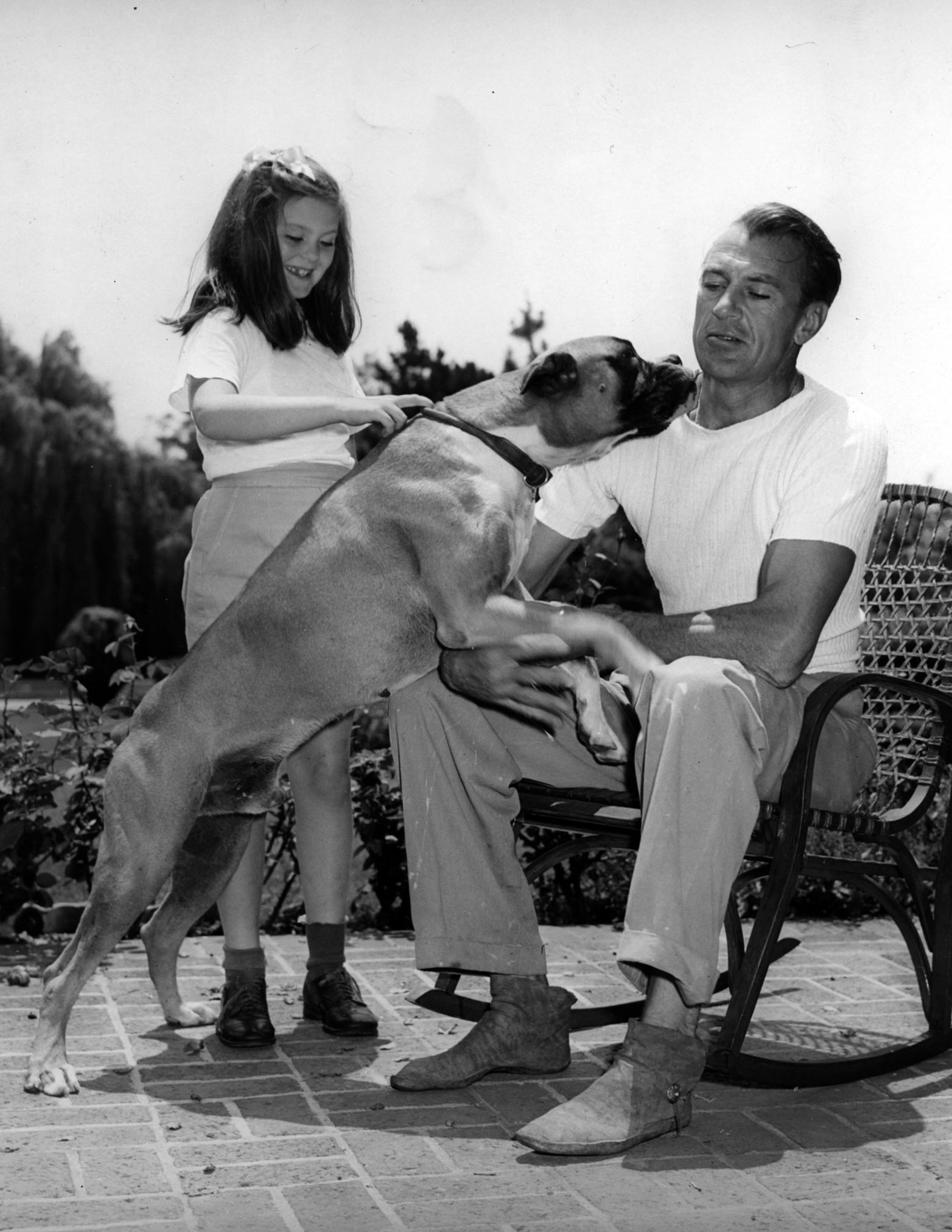 Gary Cooper with his daughter and dog, circa 1945.