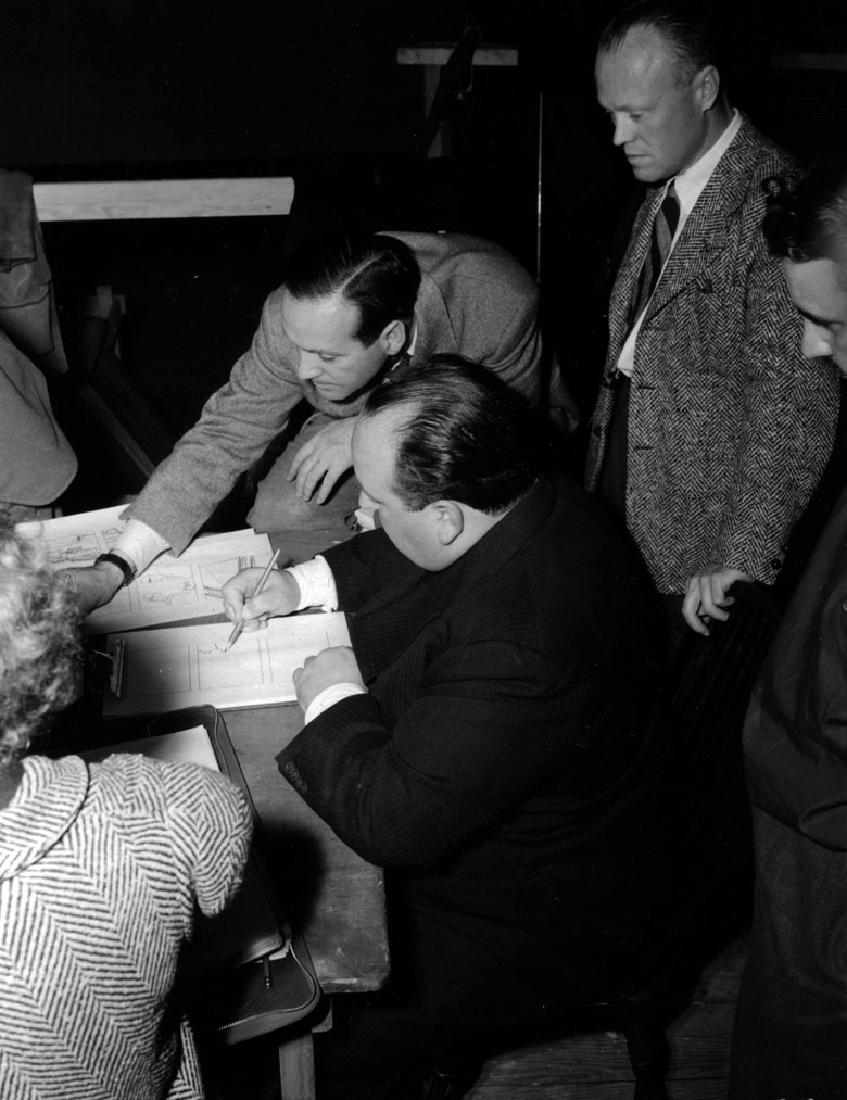 Hitchcock works on a storyboard for Foreign Correspondent.