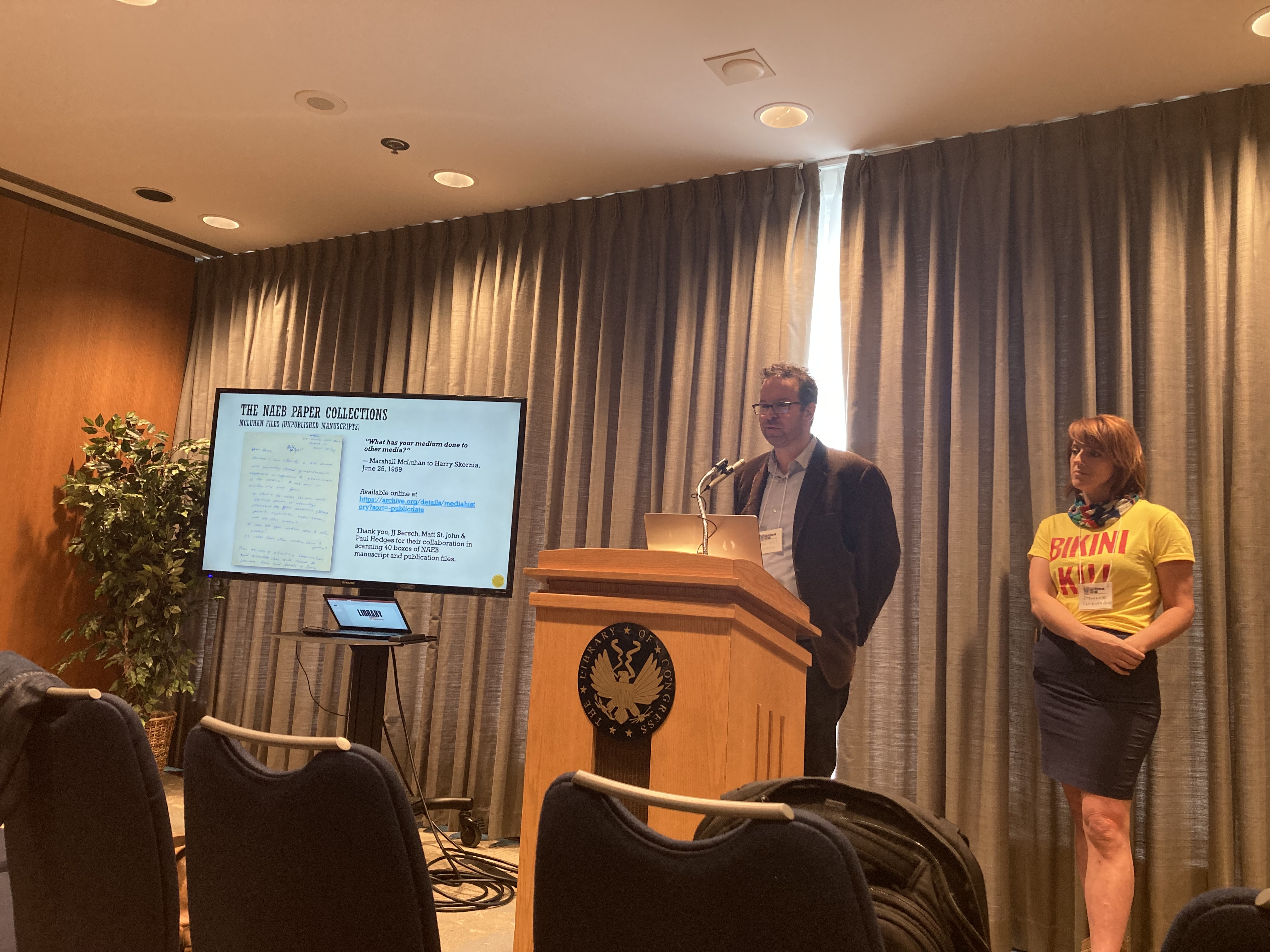 A photo of Eric Hoyt and Stephanie Sapienza presenting slides on the "NAEB Paper Collections"