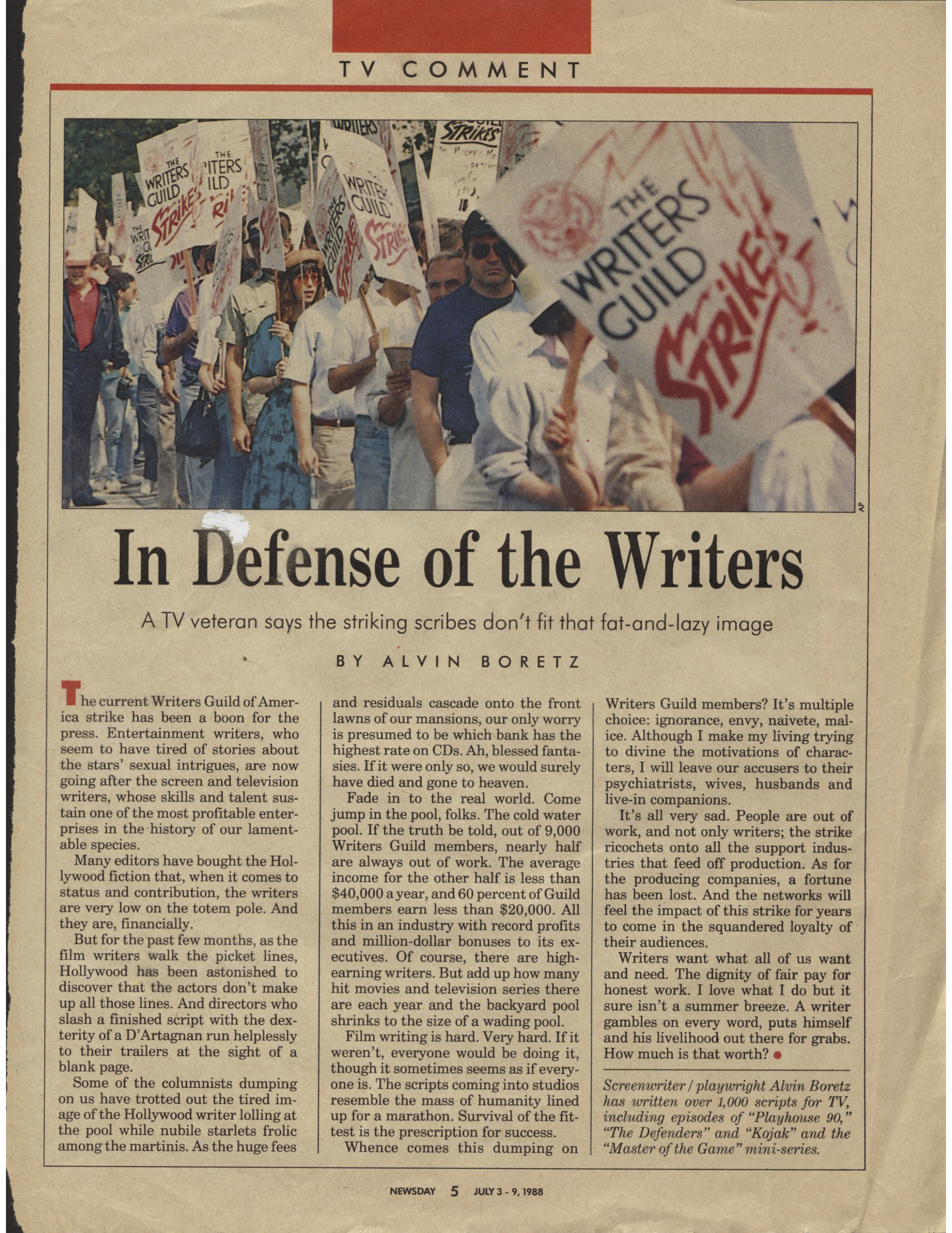 A color scan of a newspaper article. There is a photo at the top of several WGA members during the 1988 strike. The article headline is "In Defense of the Writers." There are three columns of text.