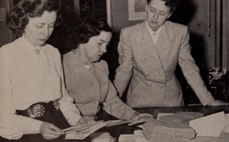 Black and white photograph of women sorting mail at a table